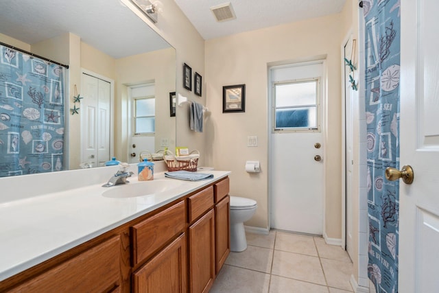 full bath with toilet, vanity, visible vents, tile patterned flooring, and baseboards