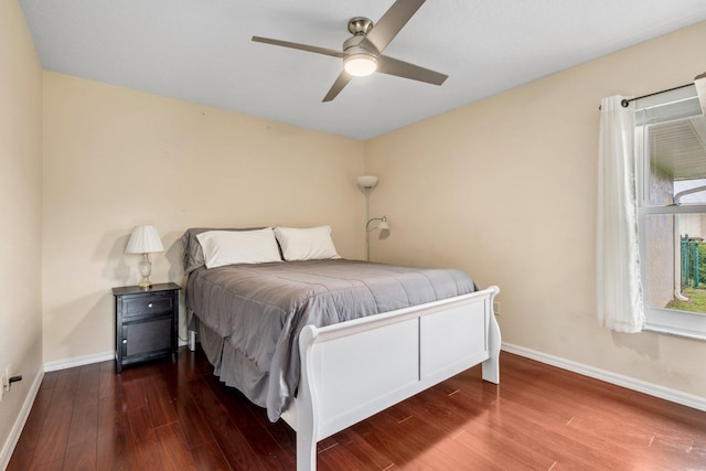 bedroom featuring baseboards, a ceiling fan, and wood finished floors