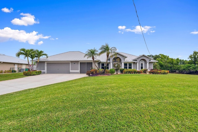 ranch-style home featuring driveway, metal roof, a garage, stucco siding, and a front yard