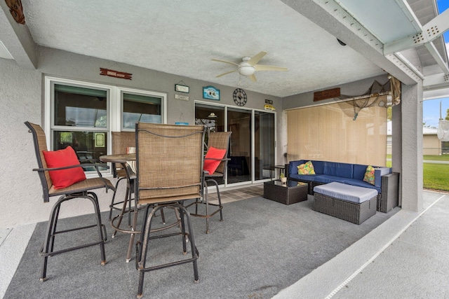 view of patio / terrace with an outdoor living space, outdoor dining space, and ceiling fan