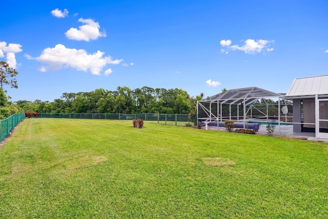 view of yard featuring a fenced backyard, a lanai, and a fenced in pool