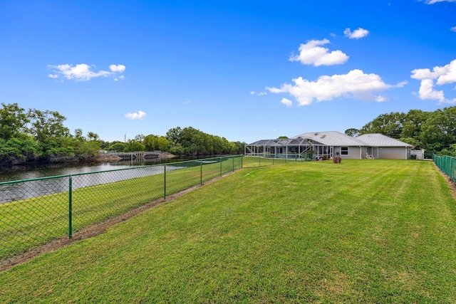 view of yard with a water view and a fenced backyard