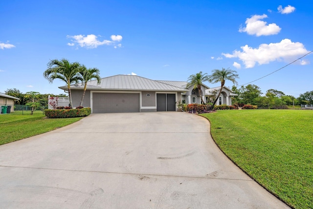 ranch-style house featuring stucco siding, concrete driveway, a garage, and a front lawn