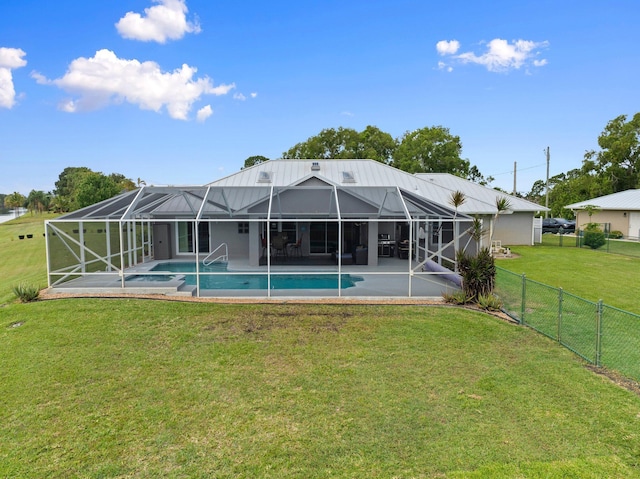 rear view of house featuring a patio area, a lanai, a fenced backyard, a fenced in pool, and a lawn