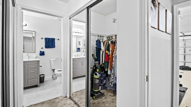 full bath with vanity, toilet, and a walk in closet