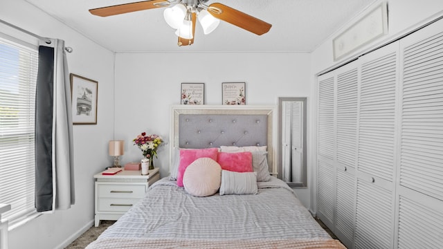 bedroom with a closet, a ceiling fan, and baseboards