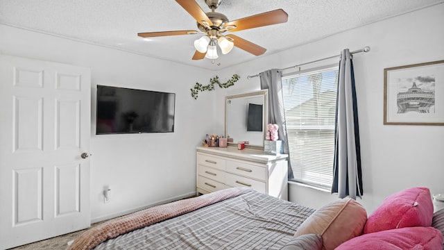 carpeted bedroom featuring a textured ceiling and ceiling fan