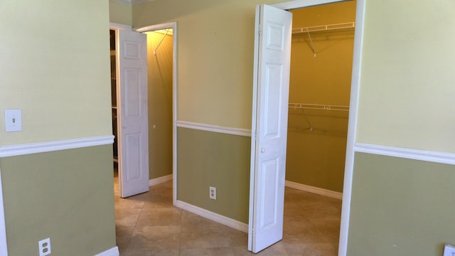 unfurnished bedroom with tile patterned floors and baseboards