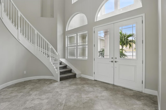 15816 Orchard Dr, Westlake, FL 33470 - foyer with baseboards, stairway, a high ceiling, and french doors