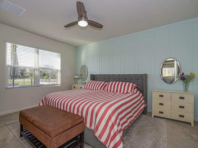 bedroom with baseboards, visible vents, light carpet, and ceiling fan