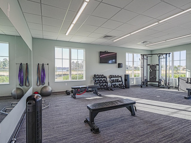 gym with visible vents, carpet flooring, and baseboards