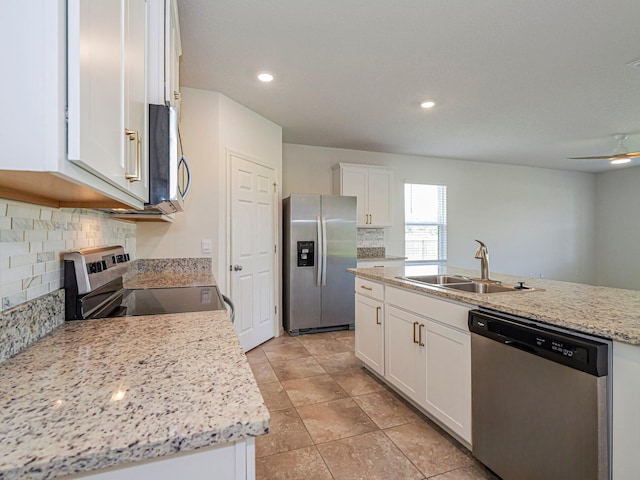 kitchen with recessed lighting, appliances with stainless steel finishes, white cabinets, backsplash, and a sink