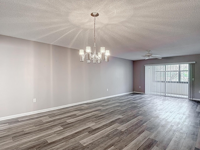 spare room with a textured ceiling, baseboards, ceiling fan with notable chandelier, and dark wood finished floors
