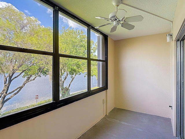 unfurnished sunroom with a water view