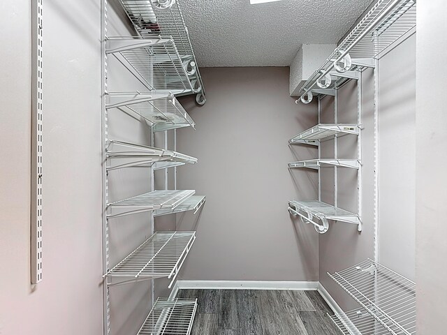 spacious closet with wood finished floors