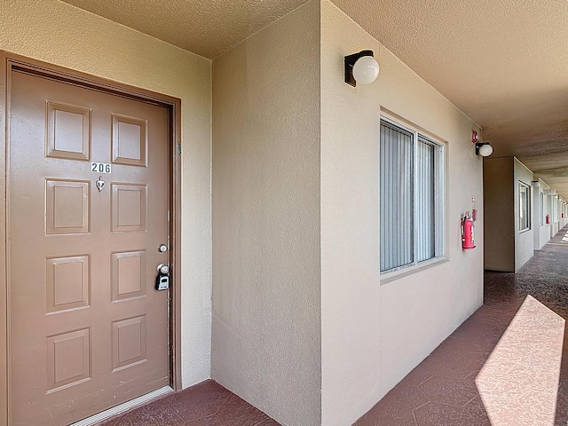 entrance to property featuring stucco siding