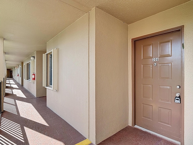 entrance to property with stucco siding