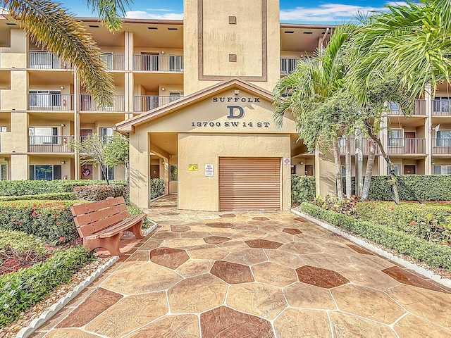view of property featuring driveway and a garage