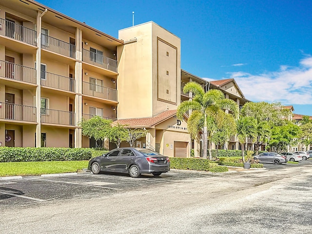 view of building exterior featuring uncovered parking