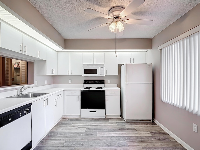 kitchen with a sink, ceiling fan, white appliances, light countertops, and a textured ceiling
