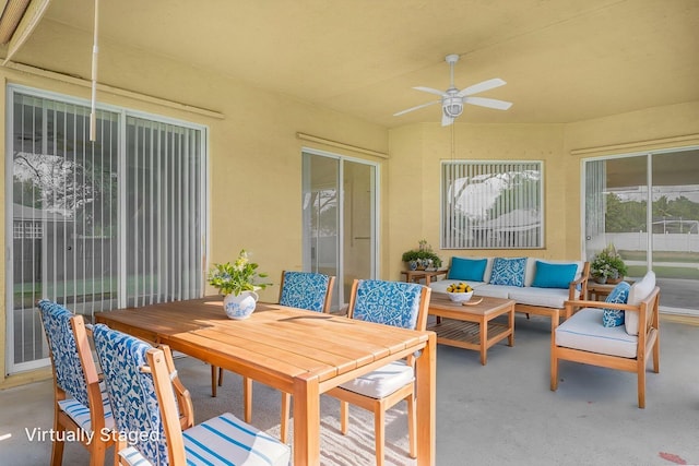 sunroom featuring outdoor lounge area, a ceiling fan, and outdoor dining area