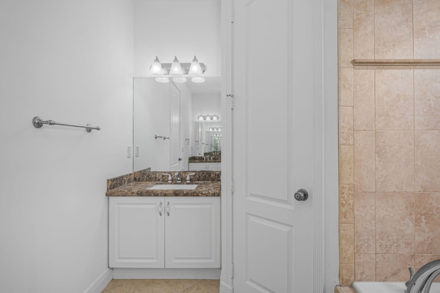 bathroom featuring tile patterned floors, a bathtub, and vanity