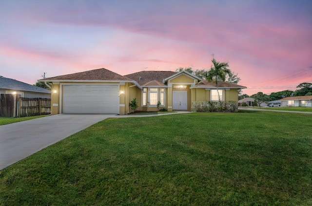 single story home featuring stucco siding, fence, a garage, a front yard, and concrete driveway