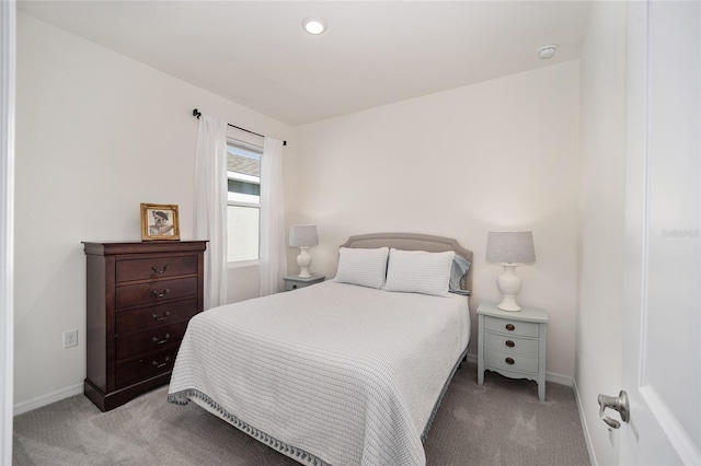 carpeted bedroom featuring baseboards