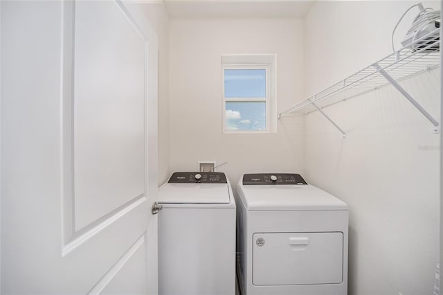 laundry room with washing machine and clothes dryer and laundry area