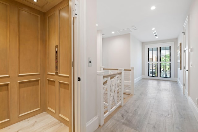 hall featuring recessed lighting, an upstairs landing, light wood-type flooring, elevator, and baseboards