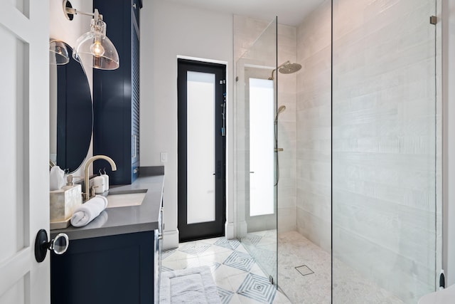 full bathroom with walk in shower, vanity, and tile patterned flooring