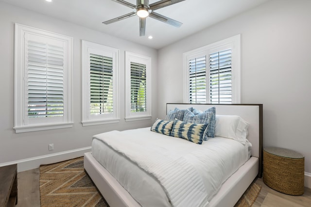 bedroom with recessed lighting, multiple windows, and baseboards