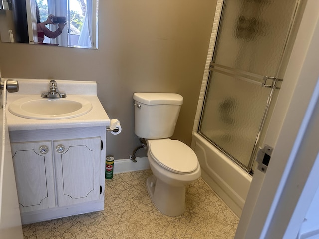 363 Monaco H, Delray Beach, FL 33446 - bathroom with vanity, toilet, baseboards, and shower / bath combination with glass door