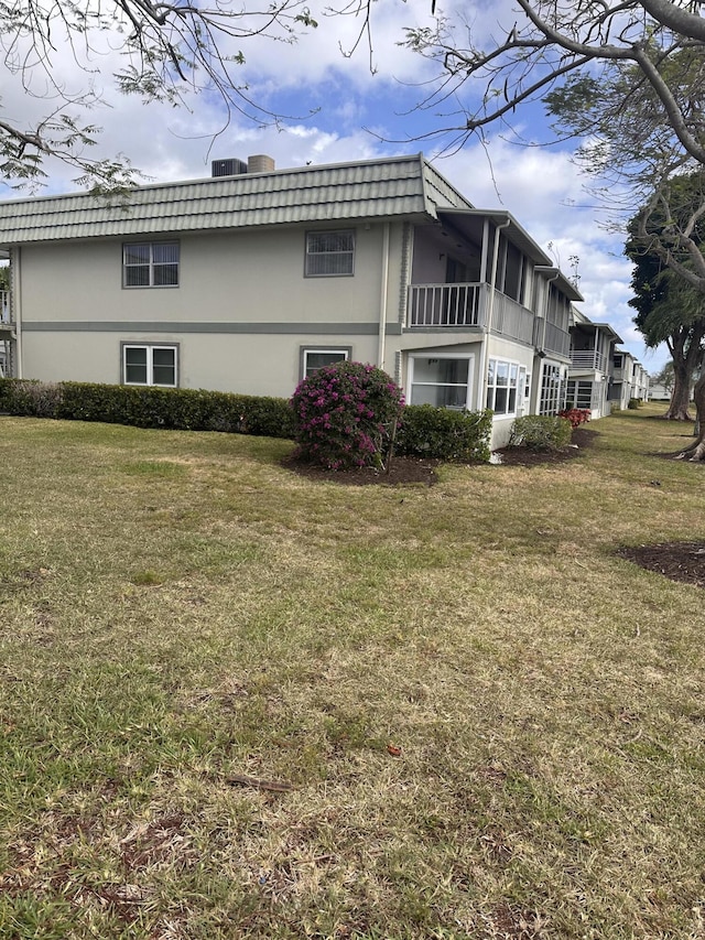 363 Monaco H, Delray Beach, FL 33446 - view of side of property with a yard and stucco siding