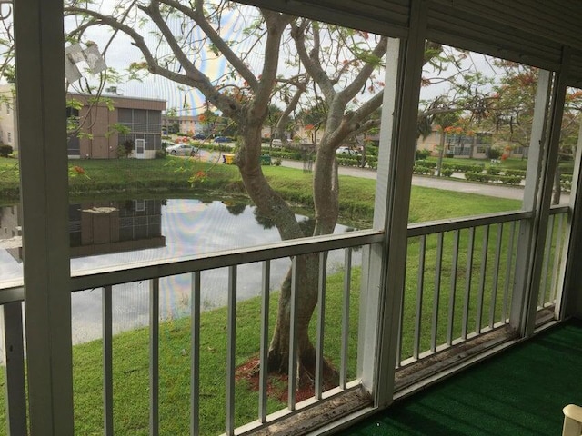 363 Monaco H, Delray Beach, FL 33446 - unfurnished sunroom with a water view