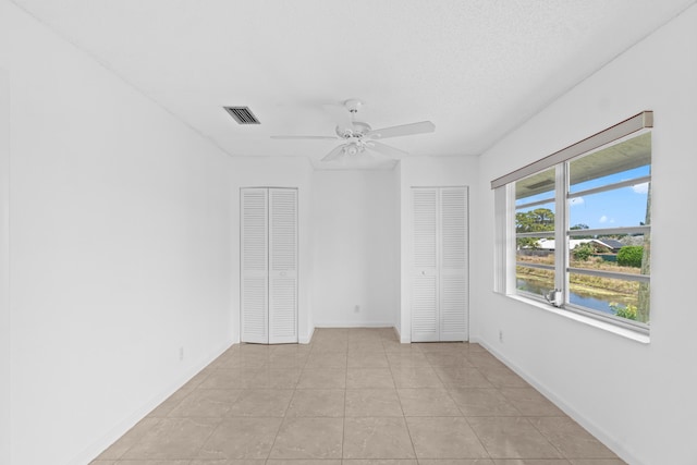 13648 Coconut Palm Ct Unit B, Delray Beach, FL 33484 - unfurnished room featuring light tile patterned floors, visible vents, a ceiling fan, and baseboards