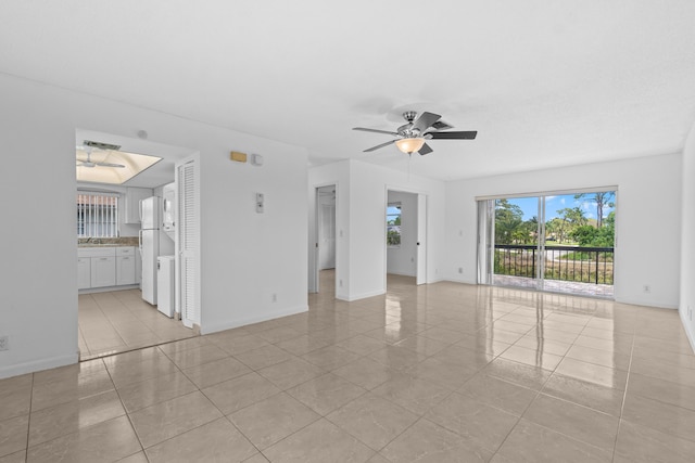 13648 Coconut Palm Ct Unit B, Delray Beach, FL 33484 - unfurnished living room with light tile patterned flooring, a ceiling fan, and baseboards