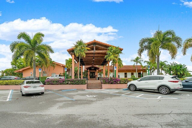 13648 Coconut Palm Ct Unit B, Delray Beach, FL 33484 - view of building exterior with uncovered parking