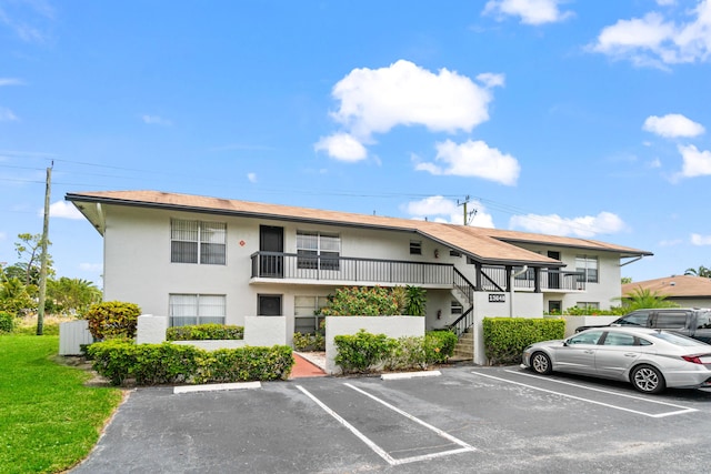 13648 Coconut Palm Ct Unit B, Delray Beach, FL 33484 - view of property featuring stairway and uncovered parking