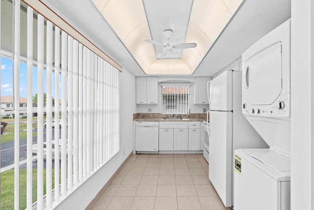 13648 Coconut Palm Ct Unit B, Delray Beach, FL 33484 - kitchen with light tile patterned floors, white cabinetry, stacked washing maching and dryer, white appliances, and a ceiling fan