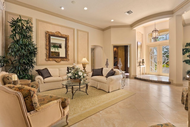 living area with visible vents, recessed lighting, french doors, arched walkways, and a notable chandelier