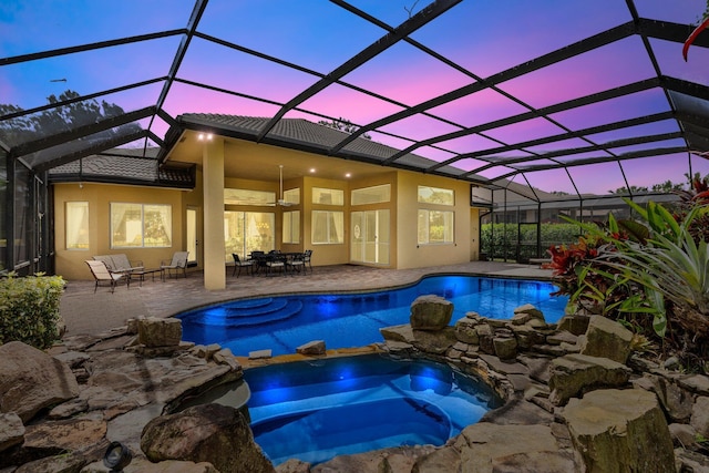 view of pool featuring a patio, outdoor dining area, and a pool with connected hot tub