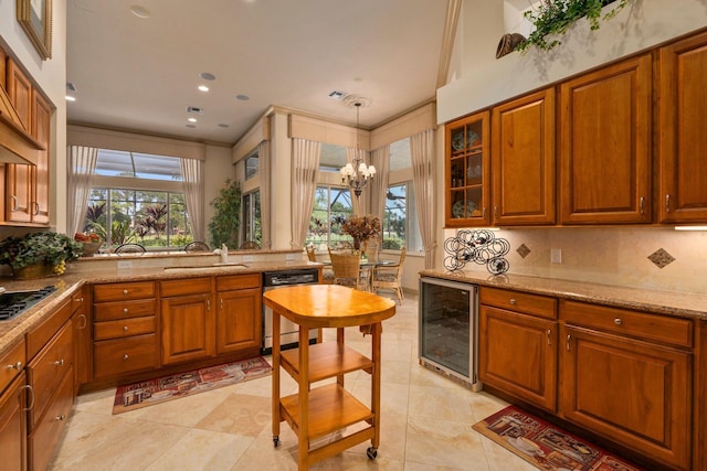 kitchen with plenty of natural light, brown cabinets, a sink, beverage cooler, and dishwashing machine