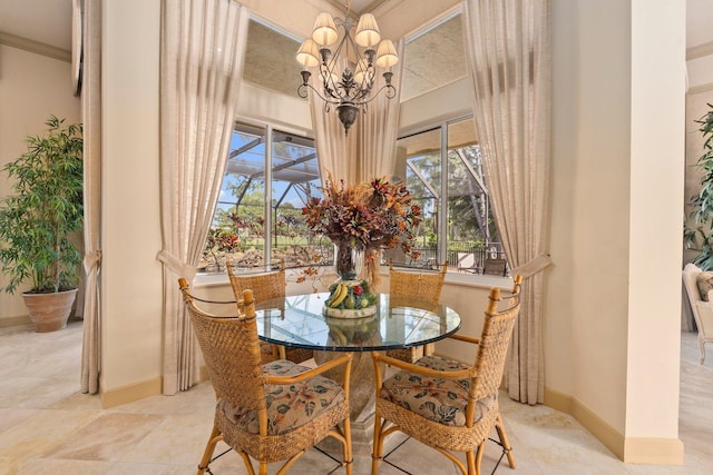 dining space featuring crown molding, baseboards, a notable chandelier, and a wealth of natural light