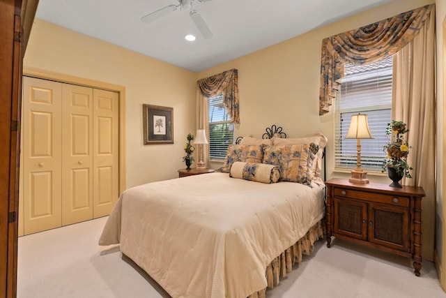 bedroom featuring a ceiling fan, recessed lighting, light carpet, and a closet