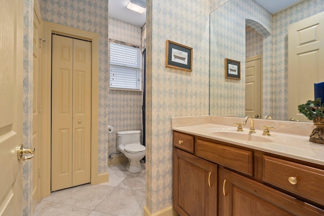 bathroom with vanity, tile patterned floors, a closet, and toilet