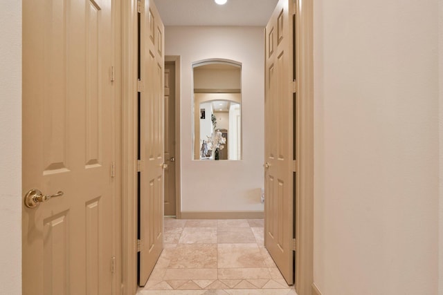 hallway featuring arched walkways