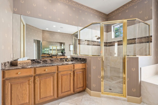 bathroom with wallpapered walls, a shower stall, tile patterned flooring, and vanity