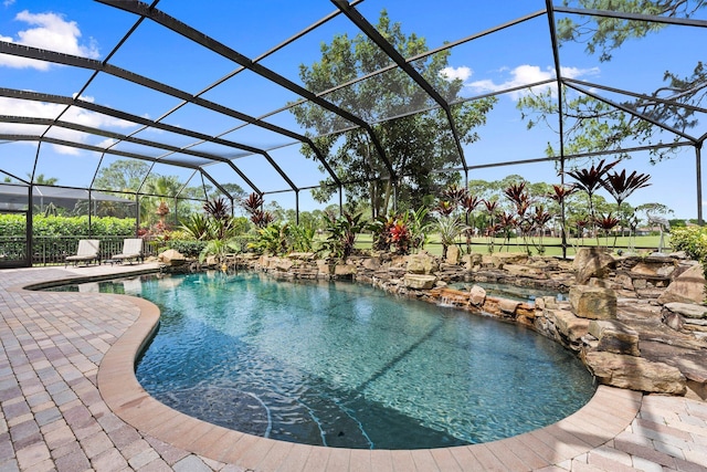 pool featuring a lanai and a patio area
