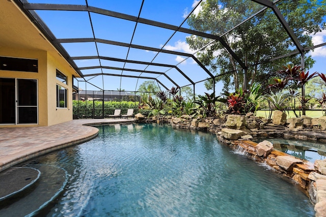 outdoor pool featuring a lanai and a patio